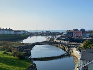a bridge over a river in a city at Harbour View in Aberaeron