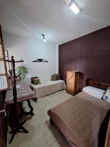 a bedroom with two beds in a room at Caminho das Pedras 206 in São Pedro da Aldeia +39 photos