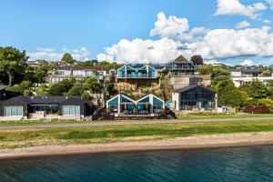 a group of houses on a hill next to the water at Roam Taupo Upper Terrace Unit 4 - Spa Pool in Taupo