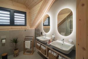 a bathroom with two sinks and two mirrors at Chatka u tatka in Vysoké Tatry +89 photos