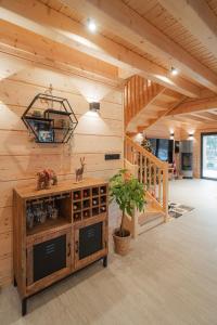 a large room with a wooden wall at Chatka u tatka in Vysoké Tatry