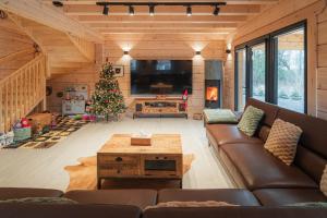 a living room with a couch and a christmas tree at Chatka u tatka in Vysoké Tatry