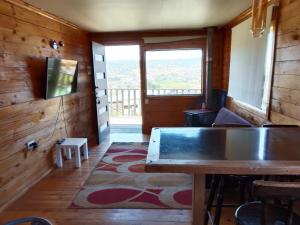 a room with a table and a large window at Cabaña tree in Boca Pupuya