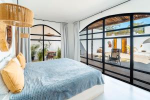 a bedroom with a bed and a view of a patio at Las Guapas Villas Tamarindo in Tamarindo +273 photos