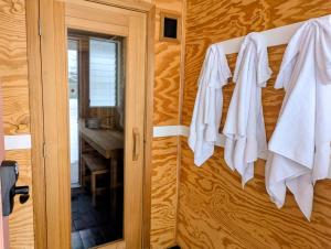 a bathroom with white towels hanging on a wooden wall at Scotty's Motel in Munising +30 photos