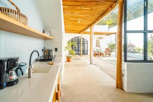 an open kitchen with a view of a patio at Las Guapas Villas Tamarindo in Tamarindo