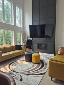 a living room with a couch and a fireplace at The Creek Home in Kemptville
