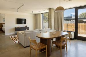 a living room with a table and a couch at Drift Nashville, a Member of Design Hotels in Nashville