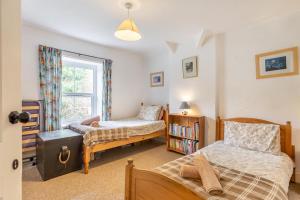 a bedroom with two beds and a window at 4 Bed in Stokenham oc-i34021 in Stokenham