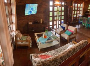 a living room with a couch and chairs and a table at Morada de las Aves in Cali