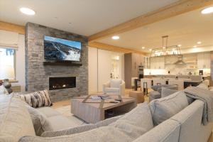 a living room with a couch and a fireplace at Okemo Mountain Lodging by Vail Resorts in Ludlow