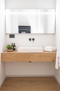 a bathroom counter with a sink and a mirror at ARIA Collection Bari in Bari