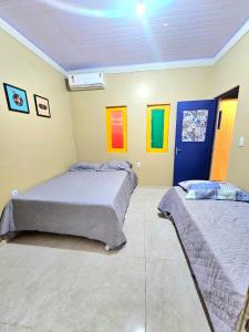 two beds in a room with colorful pictures on the wall at Hostel do Seu Tico in São Luís +45 photos