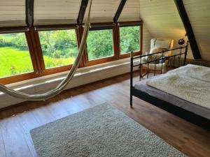 a bedroom with a bed in a room with windows at Bauernhaus Sehestedt in Sehestedt