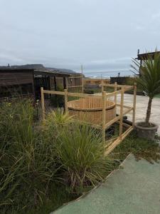 a wooden fence with a wooden tub on the beach at Casa al mare uno - Matanzas y Pupuya in Navidad