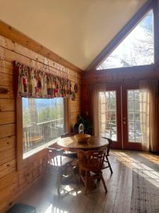 a dining room with a table and a large window at Turkey Ridge Retreat in Bryson City