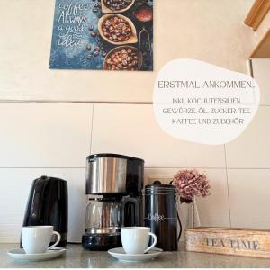 a coffee maker and two cups on a counter at Ferienhaus Landeskrone für 10 Personen mit Sauna, Terrasse, inkl Parkplatz in Dresden in Dresden +44 photos
