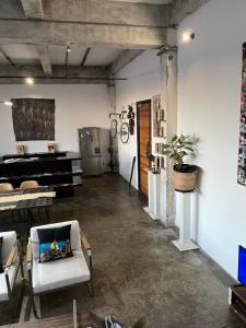 a living room with a couch and a piano at Lofty Hipster Penthouse in Johannesburg