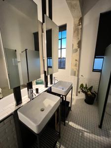 a bathroom with a white sink and a mirror at Lofty Hipster Penthouse in Johannesburg +75 photos