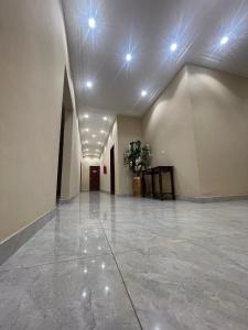 an empty hallway with lights on the ceiling at Royal Galaxy Hotel in Kumasi +2 photos