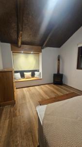 a bedroom with a bed and a large window at Morada La Granja in Minas