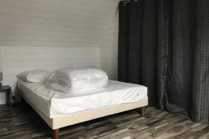 a bed with a cover on it in a room at House on Rue du Phare Town Center Hosted by Christine in Quiberon