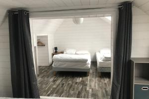 a bedroom with two beds and a mirror at House on Rue du Phare Town Center Hosted by Christine in Quiberon +38 photos