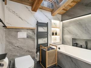 a bathroom with a tub and a toilet and a sink at Almversteck Hollersbach in Hollersbach im Pinzgau