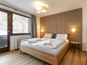 a bedroom with a large bed and a large window at Brixen Alpin Living Top 19 in Brixen im Thale