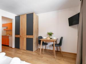 a small dining room with a table and chairs at Brixen Alpin Living Top 18 in Brixen im Thale +26 photos