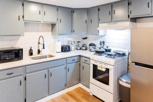a kitchen with white cabinets and white appliances at Spacious 2-Bedroom Apartment NYC-10 mins away in Union City