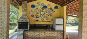 a wall with plates hanging on a wall at Flat 02 Carvalhos de Aldeia in Recife +8 photos