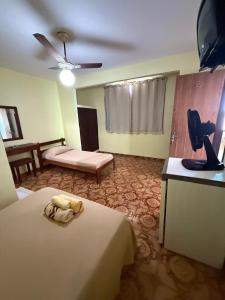 a hotel room with a bed and a couch at Pousada do Nilo in Itapemirim +11 photos