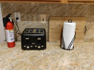 a toaster and a roll of paper towels on a counter at Beautiful Villa with Amazing 360 Mountain Views, Golfcourses close to Monserate Winery and I-15 in Fallbrook