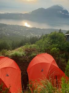 two red tents sitting on top of a hill at Batur Sunrise Camp in Kintamani