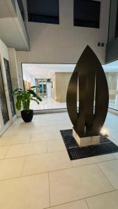 a lobby with a plant in the middle of a building at AGNI Suite Centro in Concepción del Uruguay +9 photos