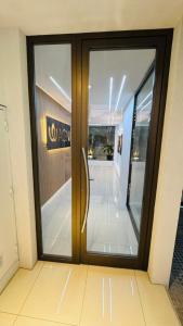 a glass door in a building with a sign on it at AGNI Suite Centro in Concepción del Uruguay