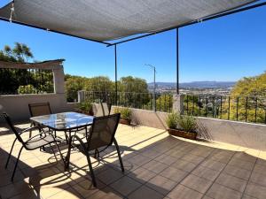 a patio with a glass table and chairs on a balcony at Mirador de San Miguel in San Miguel de Allende