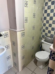a bathroom with a toilet and a sink at Mirador de San Miguel in San Miguel de Allende +70 photos