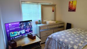 a bedroom with a bed and a television on a desk at Kings Private Room Shared Bath C in Decatur +5 photos