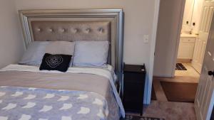 a bedroom with a bed with a large headboard at Kings Private Room Shared Bath C in Decatur