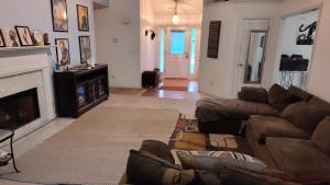 a living room with a couch and a fireplace at Kings Private Room Shared Bath C in Decatur