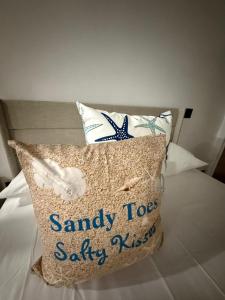 a pillow on a bed with a santa cruzsafety sidx sidx at Josie Cozy Corner in Grand Turk