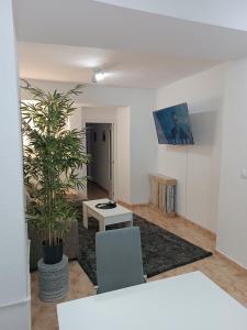 a living room with a table and a potted plant at Casa el Pato Lolo in Bolbaite