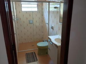a bathroom with a shower and a toilet and a sink at Casa Tapajos in Ubatuba