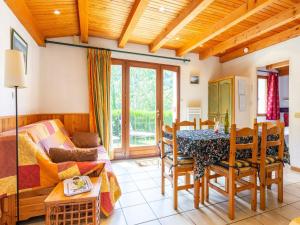a living room with a table and a couch at Chalet in Vosges Forest with Valley View in La Bresse