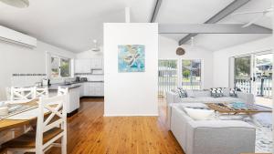 a kitchen and living room with a couch and a table at Port View on the Peninsula in Lemon Tree Passage +16 photos