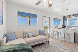 a living room with a couch and a kitchen at High Point Hideaway on the Sand Dunes - Unit 2 in Dauphin Island