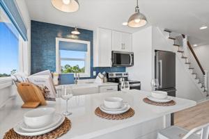 a kitchen with white cabinets and a white counter top at High Point Hideaway on the Sand Dunes - Unit 2 in Dauphin Island