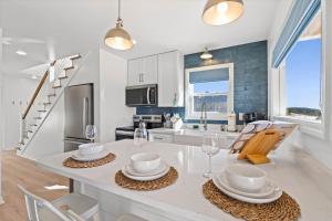 a kitchen with a table and chairs in a kitchen at High Point Hideaway on the Sand Dunes - Unit 3 in Dauphin Island